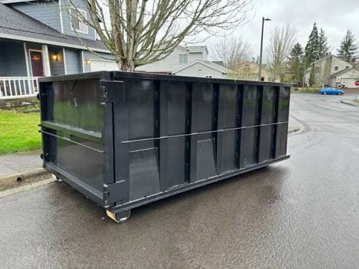 A dumpster placed on a residential street