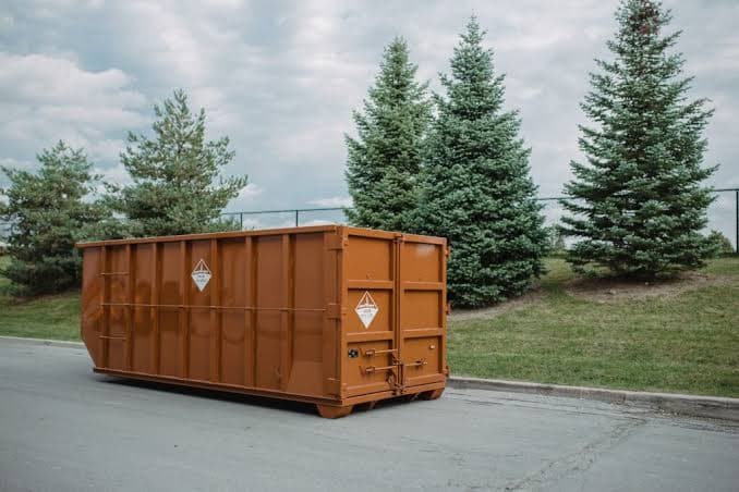 A roll-off dumpster delivered to a residential driveway